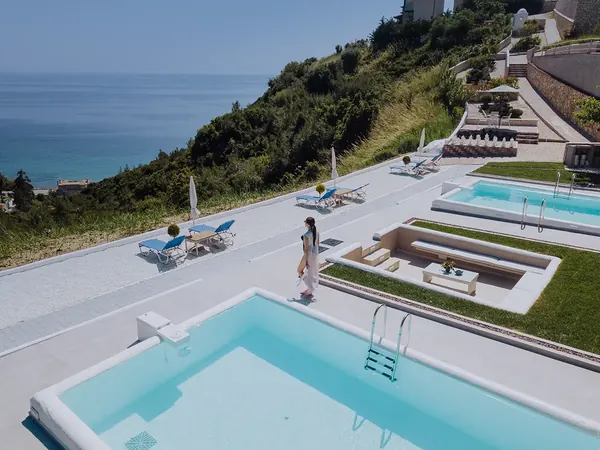 Pool terrace at Koumaros ApartHotel overlooking the coast