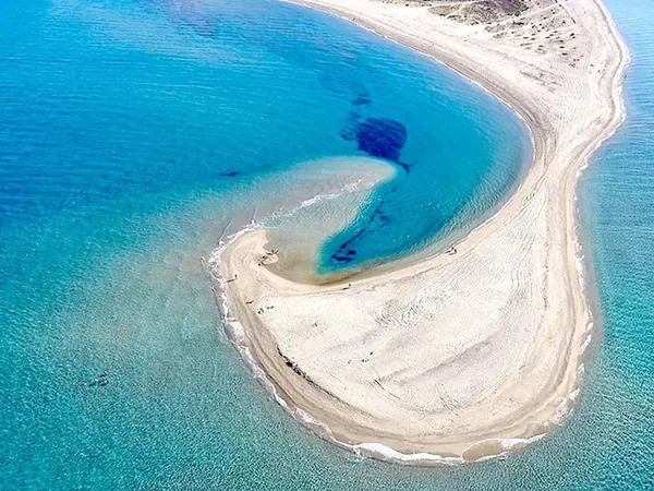 Aerial view of a sand spit and turquoise water in Kassandra